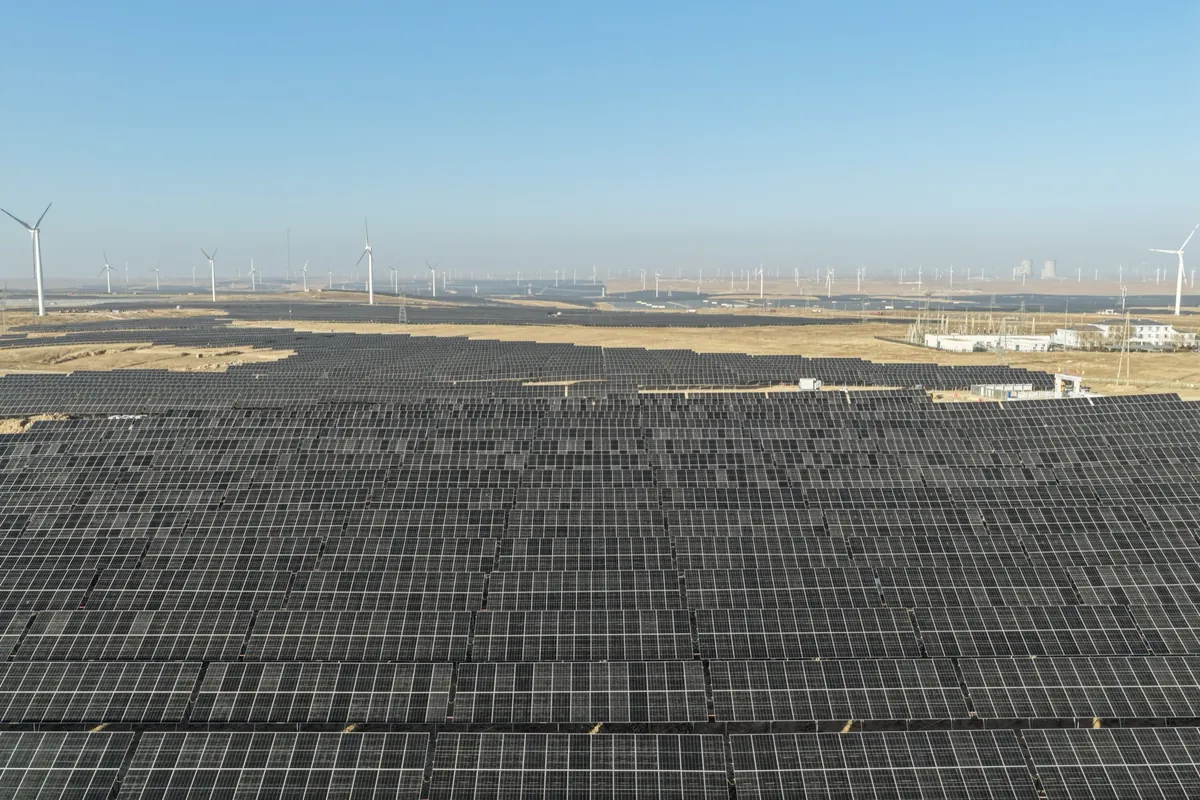 Solar and wind farms stretching across the desert edge